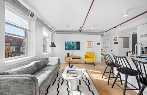Old Town Alexandria Apartment | A rare find: sun-drenched 2BR corner suite in an 1860 furniture factory turned Art Deco landmark. Bold art, King Street views, boutique-hotel design. Chef's kitchen, in-unit laundry. Steps to Old Town's waterfront. Dogs welcome.