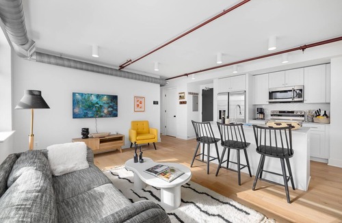 Old Town Alexandria Apartment | A rare find: sun-drenched 2BR corner suite in an 1860 furniture factory turned Art Deco landmark. Bold art, King Street views, boutique-hotel design. Chef's kitchen, in-unit laundry. Steps to Old Town's waterfront. Dogs welcome.