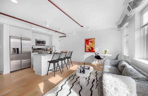 Old Town Alexandria Apartment | A rare find: sun-drenched 2BR corner suite in an 1860 furniture factory turned Art Deco landmark. Bold art, King Street views, boutique-hotel design. Chef's kitchen, in-unit laundry. Steps to Old Town's waterfront. Dogs welcome.