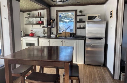 Carbonear Cottage | Escape to The Blue Bird – a cozy 2-bedroom cottage with hot tub and partial ocean views! Just 5 mins from Carbonear & 15 mins to Salmon Cove Sands.