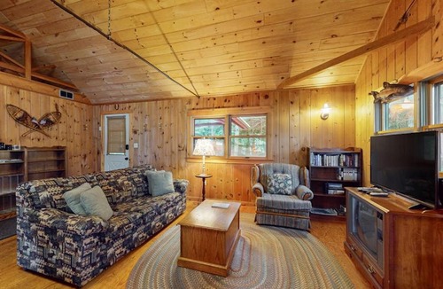 Greenville Junction House | Lakefront Home with Private Dock, Pebble Beach & Enclosed Porch - Dogs Welcome