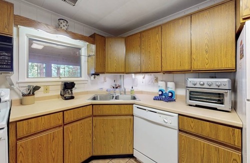 Greenville Junction House | Lakefront Home with Private Dock, Pebble Beach & Enclosed Porch - Dogs Welcome