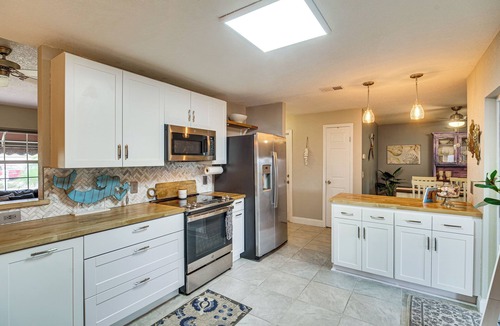 Surfside Estates Cottage | Lovely Merritt Island Home w/Kayak + Fire Pit!