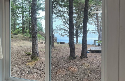 Shelter Cove Cottage | Stunning ocean view from the yard of this cozy home with balcony and fireplace
