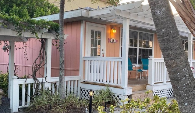 Beach across the road, pool a few steps out the door of this charming cottage.